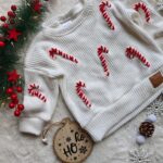 Sweterek świąteczny dla dziecka laski cukrowe ecru